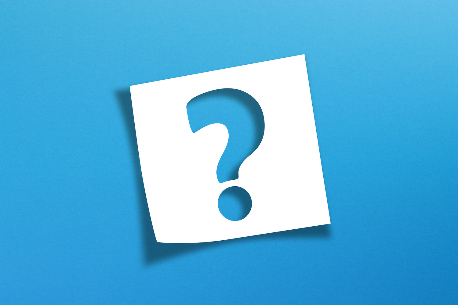 A blue question mark on a white square of paper over a blue background