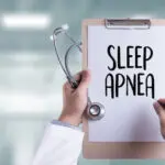 clipboard that says sleep apnea with doctor, suggesting sleep apnea affects health