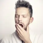 A yawning man, exhausted after no sleep